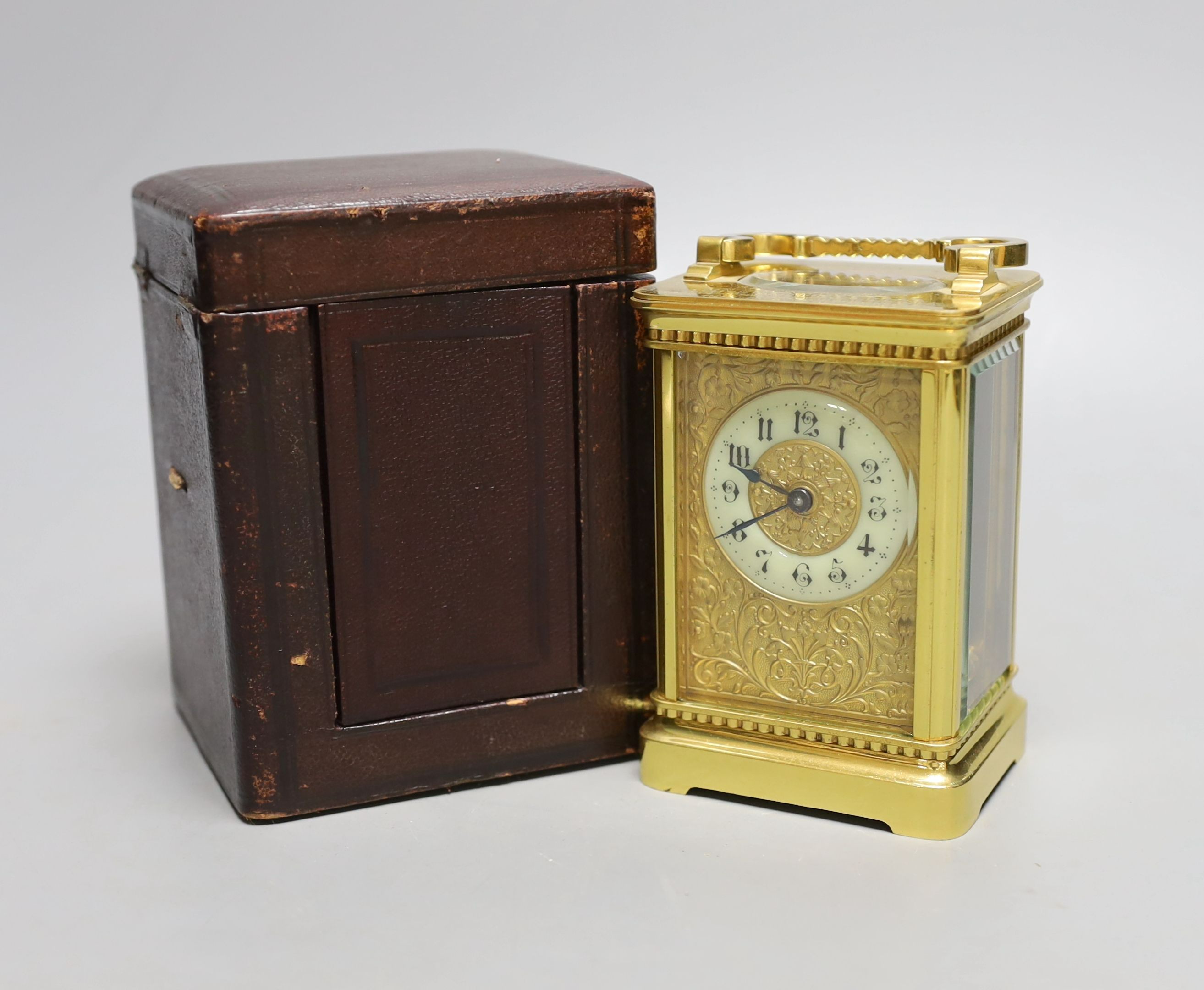 A cased French gilt brass carriage timepiece with relief cast dial and engraved presentation inscription - 14cm tall